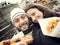 Couple while taking a Selfie eating street food