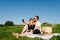 Couple taking selfie while having a picnic in a countryside on a green grass