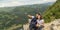 Couple taking a selfie at mountain viewpoint