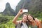 Couple taking selfie with smartphone hiking Hawaii