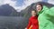 Couple taking selfie video on cruise ship, Milford Sound, Fiordland, New Zealand