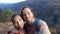 Couple taking selfie video having fun on hike on Hawaii