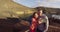 Couple taking selfie video in volcano mountains of Lanzarote on tourist travel