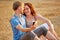 Couple taking smartphone selfie at beach