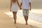 Couple taking a walk holding hands on the beach