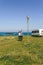 Couple taking a walk near the coast with a camper