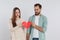 Couple tearing paper heart on  background. Relationship problems