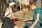 Couple of teenagers relaxing and playing a board game throwing dice, city street background