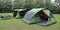 A couple of tents that are in the grass created with Generative AI technology