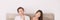 Couple thinking looking up at white copy space panoramic banner. Healthy relationship at home
