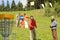 Couple throwing frisbee disc at springtime park