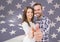 couple thumbs up against fluttering american flag