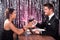 Couple toasting wineglasses at restaurant table