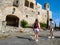 A couple of tourists approach to the walls of the castle Montfalco Murallat, La Segarra, Lleida province in Catalonia, Spain