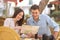 Couple tourists consulting a guide in a restaurant