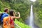Couple tourists on Hawaii by waterfall