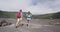 Couple tourists hikers walking on Kilauea Iki crater trail hike in Big Island, Hawaii. USA summer travel vacation