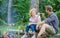 Couple tourists hold gesture while sit log bonfire. Man and girl play hand game. Couple play hand game. Hand gesture