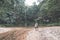 Couple of tourists looking at a stunning multicolored natural pool and waterfall in the rainforest of Lambir Hills National Park,