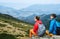 Couple tourists sitting on the cliff in the mountains