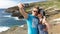 Couple tourists taking self portrait with camera phone on Hawaii, Oahu