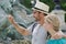 Couple tourists throwing coins in trevi fountain water