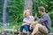 Couple tourists throwing their gesture while sit log bonfire. Man and girl play hand gesture game. Couple play hand game