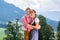 Couple in Tracht standing on meadow in alp mountains