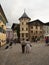 Couple in traditional clothes walking through historic old city center town of Berchtesgaden Upper Bavaria Germany