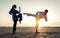 Couple training in martial arts on the beach