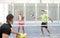 Couple training in paddle tennis class