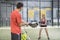 Couple training paddle tennis in court with racket and balls