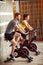 Couple trains on bike in gym