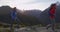 Couple Tramping Against Mountains At Routeburn Track In Fiordland National Park