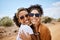 Couple travel portrait, Dubai desert with summer sunglasses or care free tourism road trip together. Happy black women