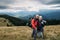 Couple traveler with backpacks in the alps, hikers in the mountains, happy active lifestyle, hiking man and woman