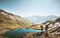 Couple travelers holding hands on mountain cliff over lake together