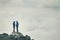 Couple Travelers in love standing on cliff together