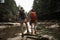 Couple of travelers standing on the stone and holding hands