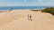 couple travelers tourists walking sandy dunes on beautiful Patara Beach on Mediterranean sea coastline. stunning desert