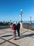 Couple of travelers using map for sightseeing at waterfront promenade Lungomare