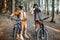 Couple traveling with bicycles in the forest