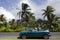 Couple traveling by convertible car in a Pacific Island