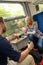 Couple traveling by train eating sandwiches hungry