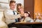 Couple with tray of wine and food in hotel room