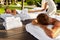 Couple Treatment At Spa. People Enjoying Relax Massage Outdoors