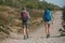 Couple of trekkers walking at the top with backpack