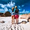 Couple at tropical beach wearing rash guard