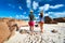 Couple at tropical beach wearing rash guard