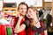 Couple is trying Dirndl or Lederhosen in a shop